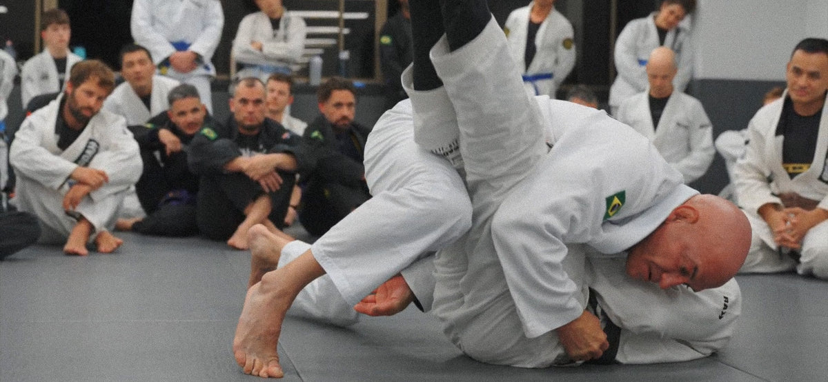 Adults practising Brazilian Jiu-Jitsu techniques during training