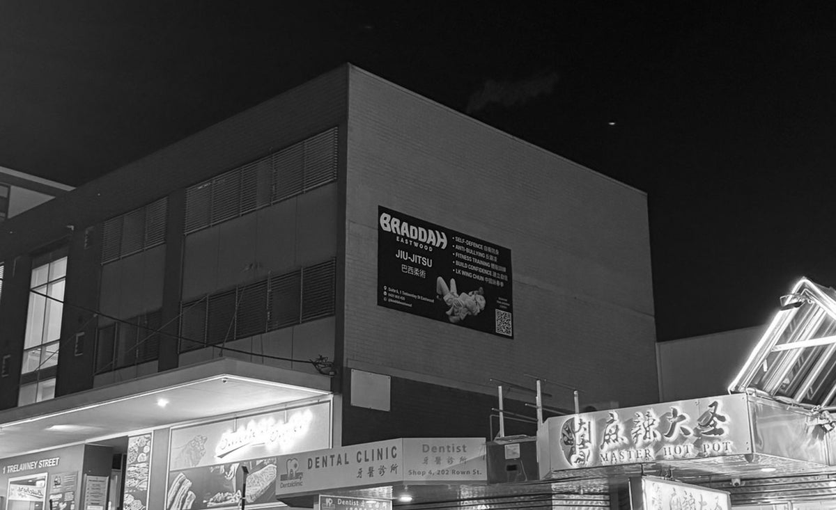 Braddah Jiu-Jitsu Eastwood academy exterior at night with branded signage