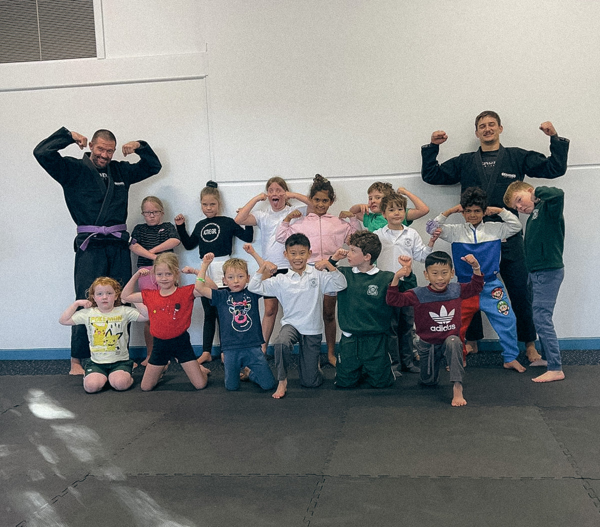 Braddah Jiu-Jitsu kids posing with instructors after a training session