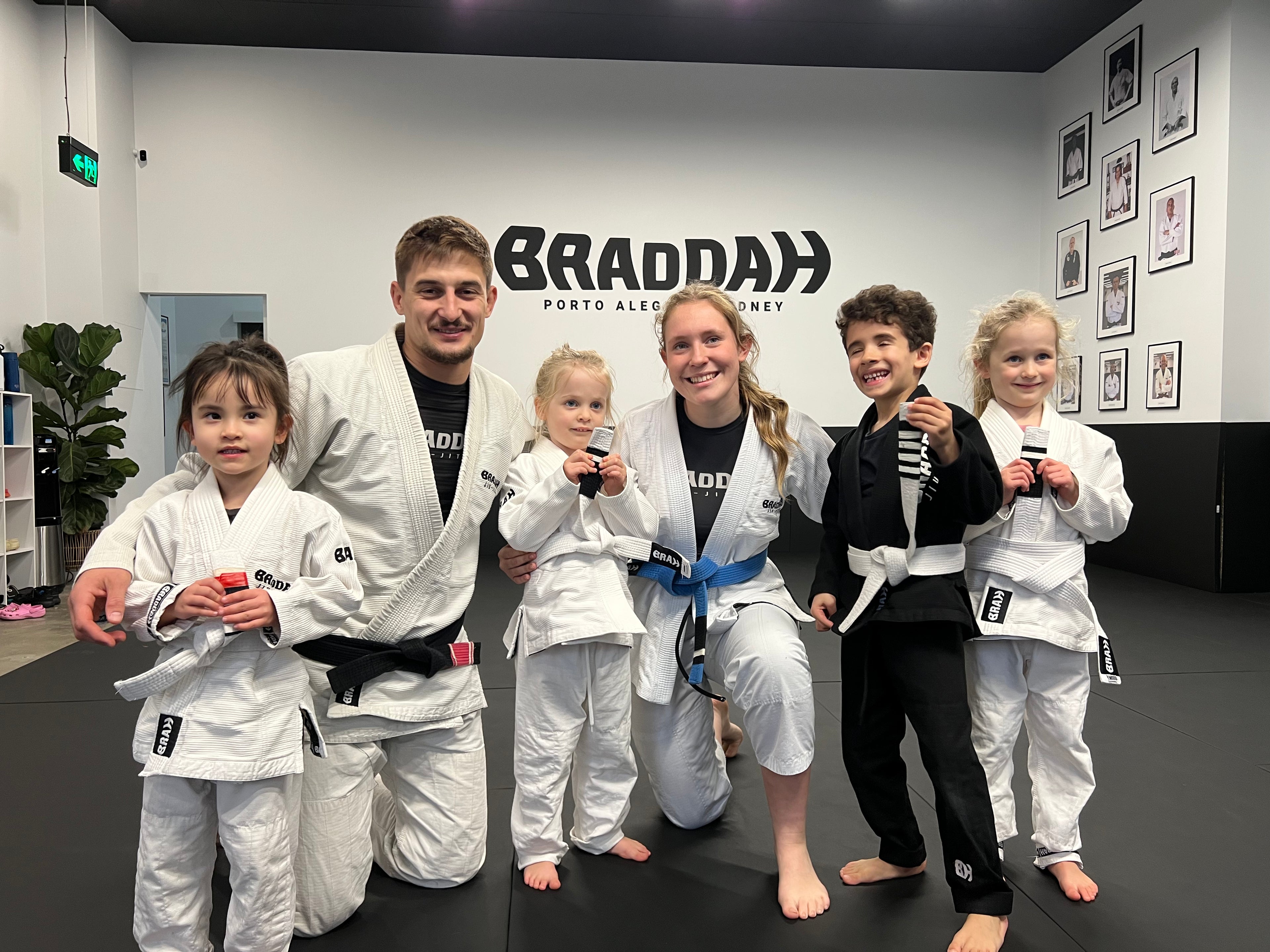 Braddah Jiu-Jitsu instructors and children posing together at the academy