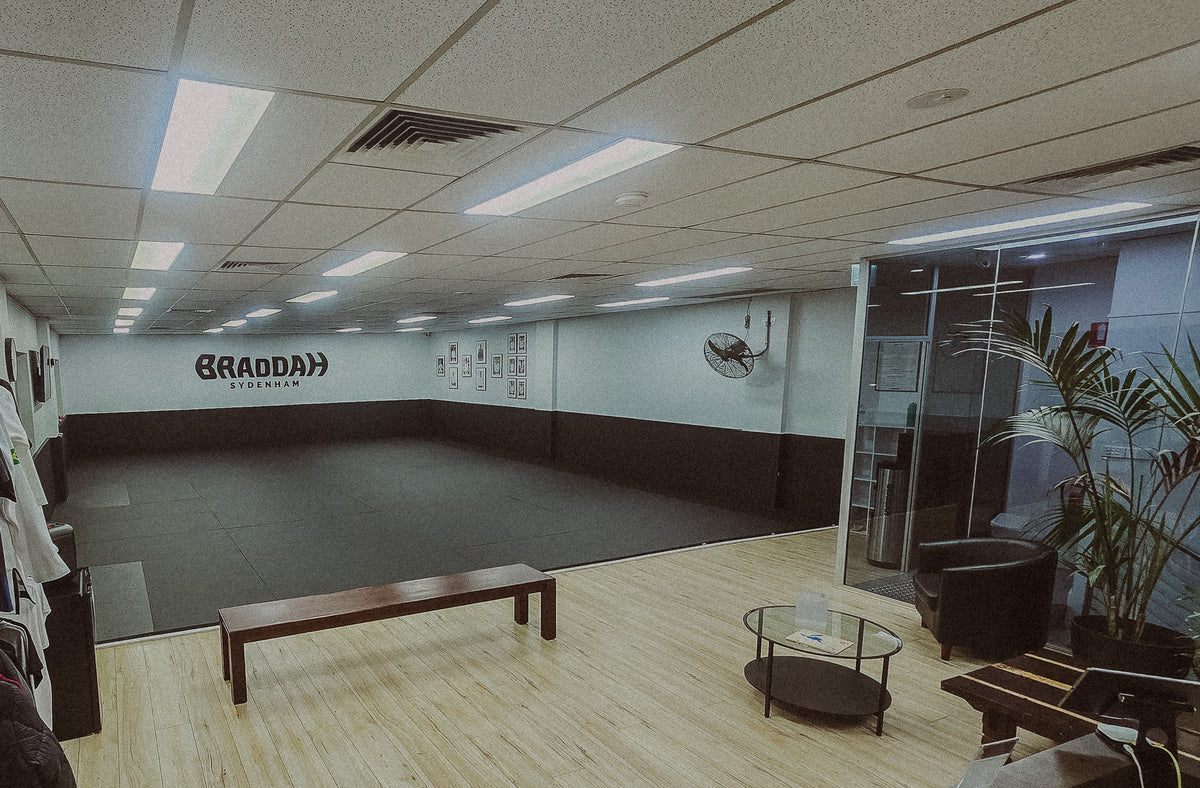 Braddah Jiu-Jitsu Sydenham academy interior with training mats and branded wall