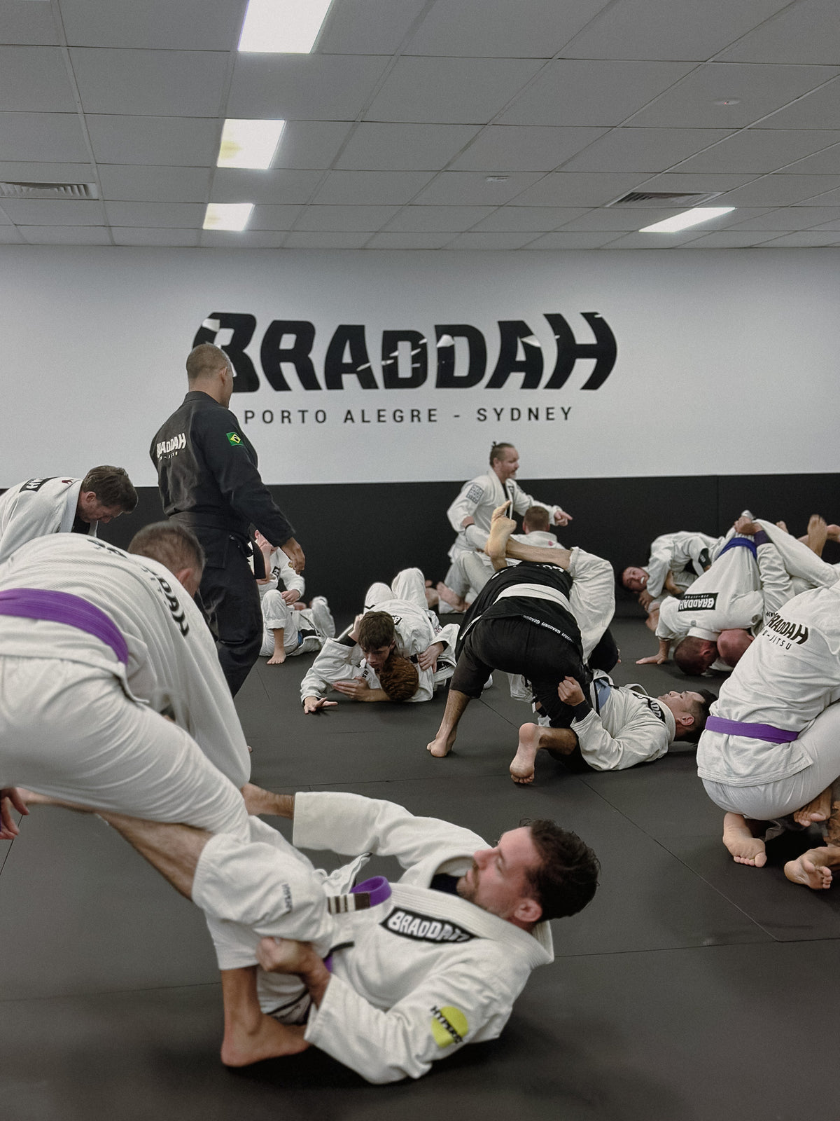 Braddah Jiu-Jitsu Sydenham students practicing Brazilian Jiu-Jitsu techniques on the training mats
