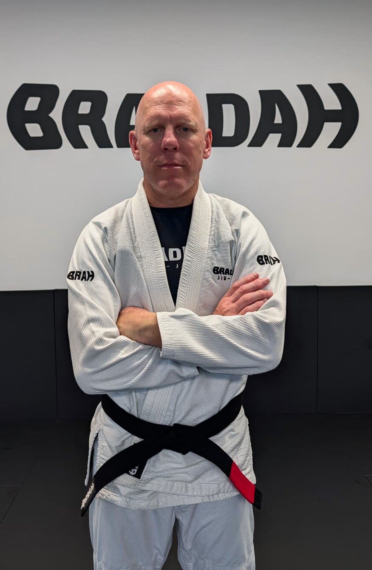 Brett “Gibbo” Gibson, Braddah Jiu-Jitsu coach wearing a black belt